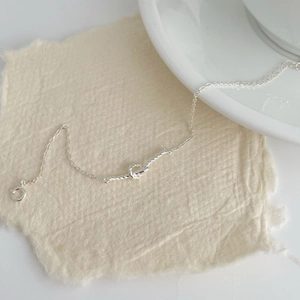 Detail of S925 sterling silver braided love knot bracelet with secure spring ring clasp