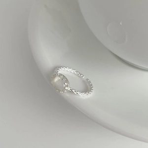 Close-up of S925 silver adjustable ring featuring an oval moonstone in crown setting
