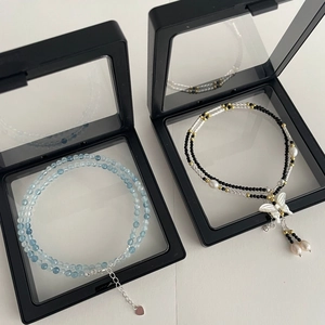 Detail of S925 silver beaded necklaces with blue aquamarine beads and pearl butterfly pendant