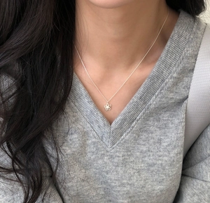 Close-up of S925 silver double-layer hollow flower pendant necklace on a model collarbone