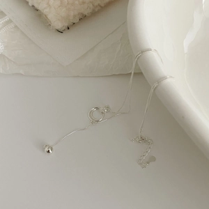 Detailed close-up of S925 sterling silver interlocking rings and polished orb on a chain