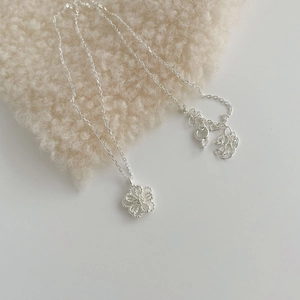 Detail shot of the S925 sterling silver hollow flower pendant with matte and polished texture
