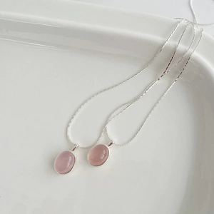 Elegant S925 sterling silver necklaces with oval pink chalcedony pendants on a white plate