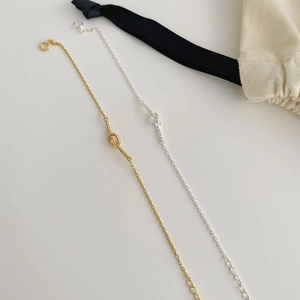 Close-up of S925 sterling silver woven heart bracelets in gold and silver finishes
