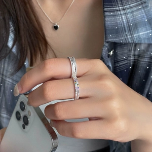 Detail of S925 silver rings with colorful mini gemstones and beaded texture on hands