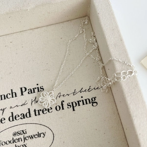 Macro shot of S925 sterling silver hollow flower pendant with delicate chain detailing