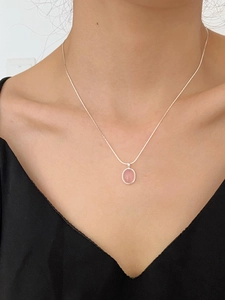 Close-up of S925 sterling silver necklace with oval pink chalcedony on a snake chain