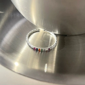 Detailed macro of S925 silver ring featuring rainbow zircons and textured band