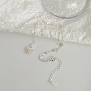 Detail of S925 sterling silver flower pendant with fine texture and hallmark