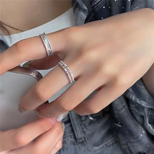 Close-up of S925 silver rainbow zircon rings worn by a model with beaded texture details