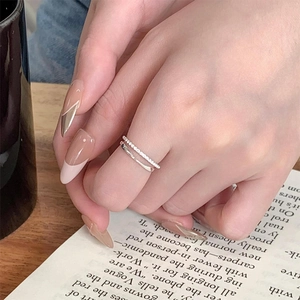 Close-up of a double-layered S925 sterling silver ring with cubic zirconia on a hand