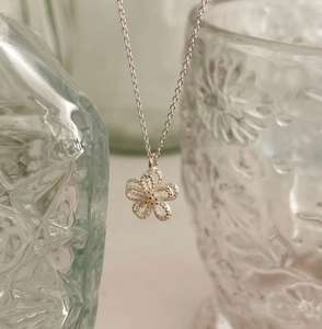 Close-up of S925 silver double-layer hollow flower pendant with lace texture and fine chain