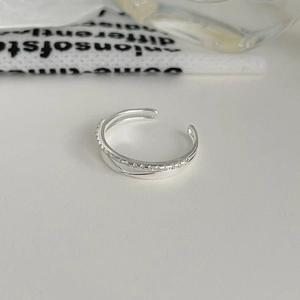 Detailed macro shot of a double-layered S925 sterling silver ring with micro-pave cubic zirconia