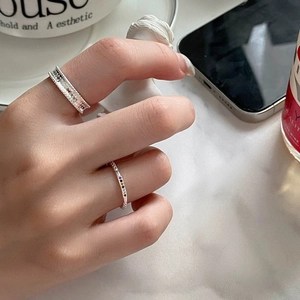 Detailed view of S925 silver rainbow gemstone ring and textured band on model's hand