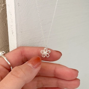 Elegant S925 sterling silver necklace featuring a hollow double-layer flower pendant