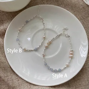 Detail of S925 silver beaded bracelets with freshwater pearls and blue gemstones