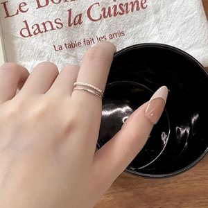 Detail of S925 sterling silver double layer ring with sparkling pavé cubic zirconia