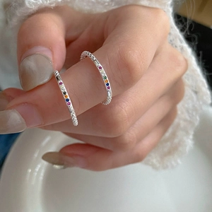 Minimalist S925 sterling silver rainbow zircon open ring shown on a model's hand