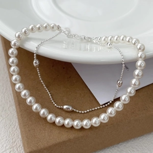 Detail view of double-layered S925 silver bracelet with pearls and metal bead chain
