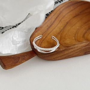 Detail of S925 sterling silver double-layer open ring with minimalist textures