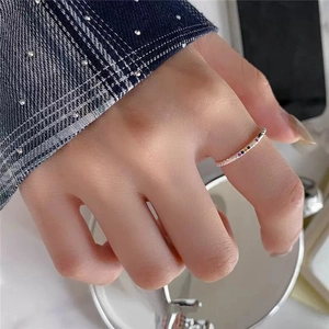 Macro detail of a slim S925 silver ring featuring vibrant rainbow cubic zirconia stones