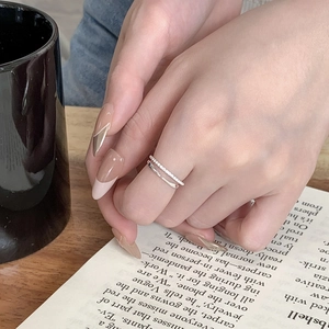 Close-up of minimalist S925 sterling silver double-layer chain ring with micro-pave cubic zirconia