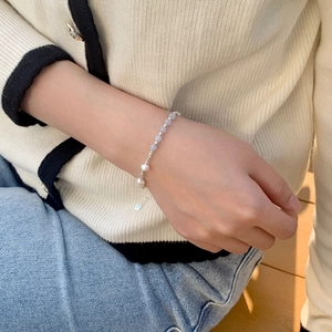 Detail of S925 silver beaded bracelet featuring natural freshwater pearls and blue gemstones