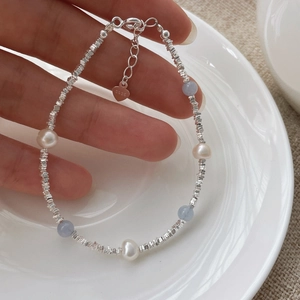 Close-up of S925 silver beaded bracelet with natural pearls and blue aquamarine stones