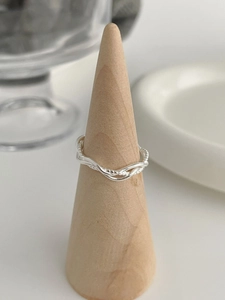 Detail of S925 sterling silver multi-layer twisted ring on a wooden cone display