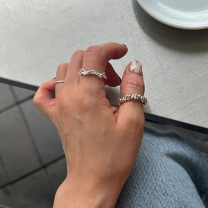 Close-up of S925 sterling silver multi-layer twisted rings worn by model on hand