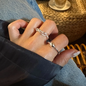 Detail view of S925 sterling silver multilayer twisted and beaded rings on model hand