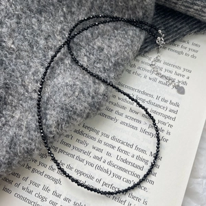 Detail of faceted black spinel beads with S925 silver lobster clasp and heart charm