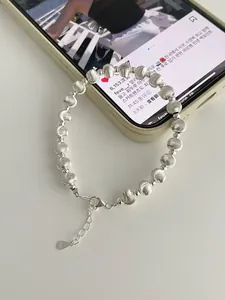 Detail of S925 sterling silver beaded bracelet with brushed texture and lobster clasp