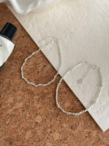 Detail of S925 sterling silver layered bracelets with snake bone and bamboo link textures