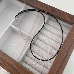 Detail of faceted black spinel beads with S925 sterling silver heart clasp and chain