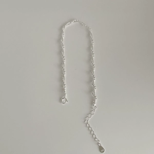 Detailed view of S925 sterling silver chain with mini beads and lobster clasp closure