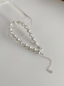 Detail of S925 sterling silver beaded bracelet showing brushed texture and lobster clasp