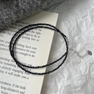 Detail of black spinel beaded necklace with S925 silver heart tag and extender chain