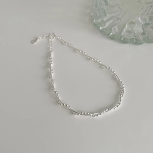 Macro detail of S925 sterling silver chain with adjustable extender and logo tag