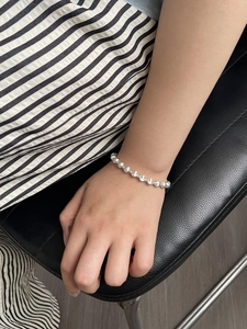 Polished silver beaded bracelet for women shown worn on wrist for a daily minimalist look