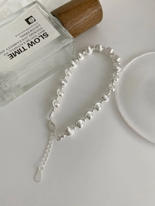 Macro shot of S925 sterling silver cat-eye bead bracelet with lobster clasp and extension chain