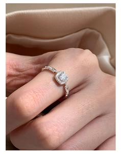 Macro shot of square sugar-cube ring with halo diamonds and geometric chain band