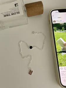 Détail du bracelet chaîne Figaro en argent S925 avec une pierre d'onyx noire