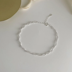 Detailed macro shot of S925 sterling silver chain with lobster clasp and adjustable links