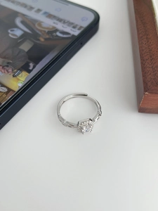 Macro detail of S925 sterling silver ring featuring a square center stone and chain design