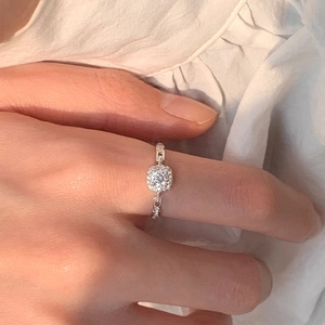Macro detail of silver halo square ring with chain band on a model hand