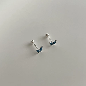 Macro detail of blue enamel butterfly stud earrings with secure screw back closure