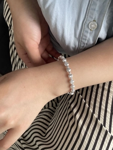 Detail shot of a S925 sterling silver beaded bracelet with alternating disc and ball charms