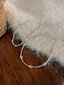 Close-up of minimalist S925 sterling silver snake and bamboo joint chain bracelet set