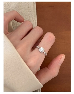 Detailed view of silver square zircon ring with halo setting and chain texture band